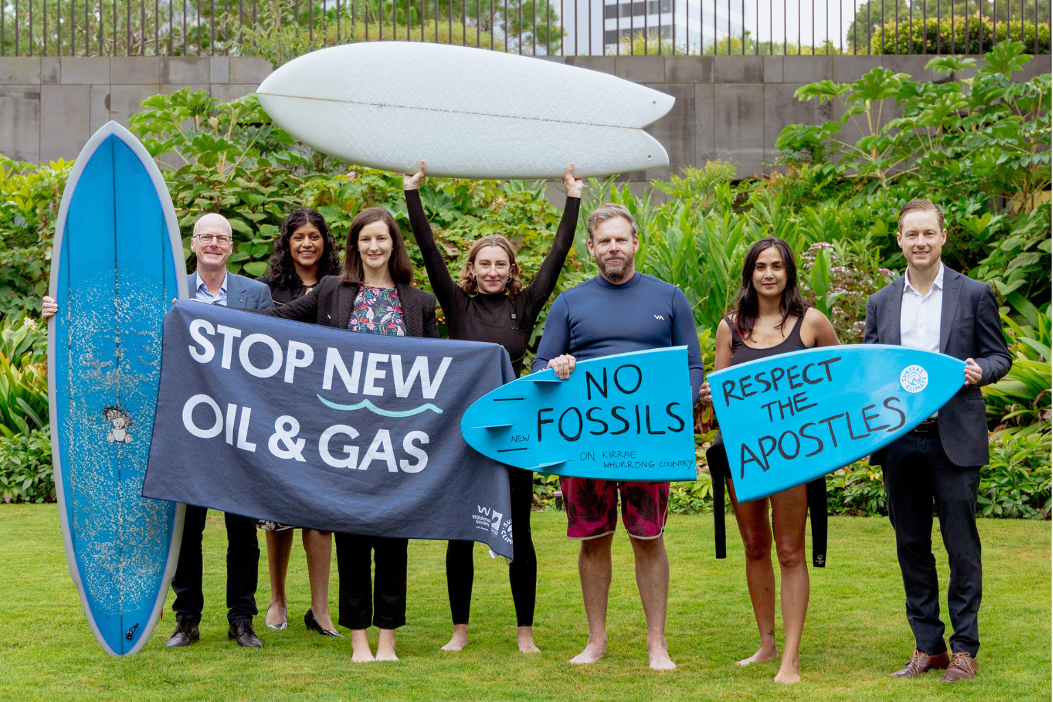 7 people holding signs that say stop new oil and gas and no fossils respect the apostles.